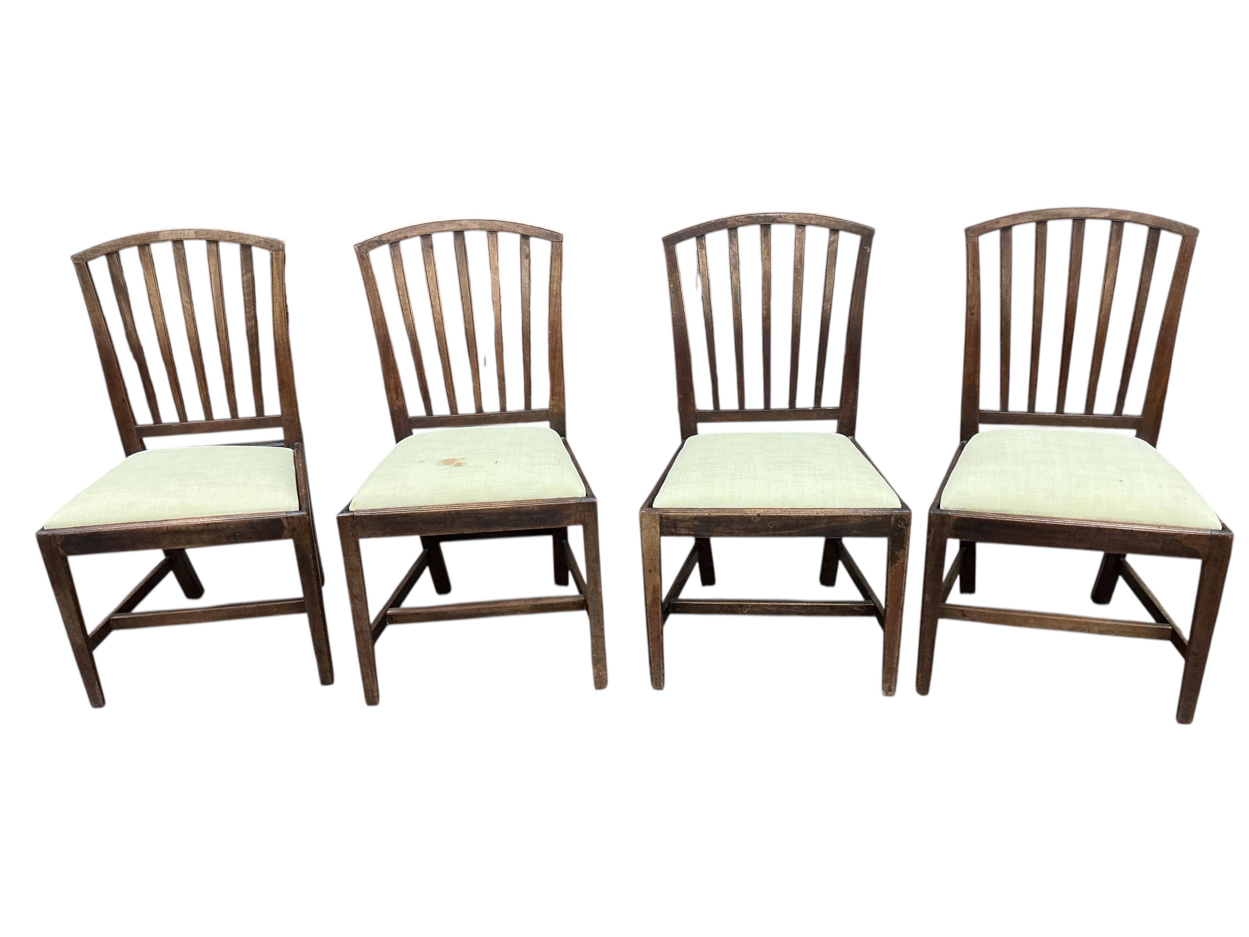 A set of six George III mahogany dining chairs with two matching later elbow chairs